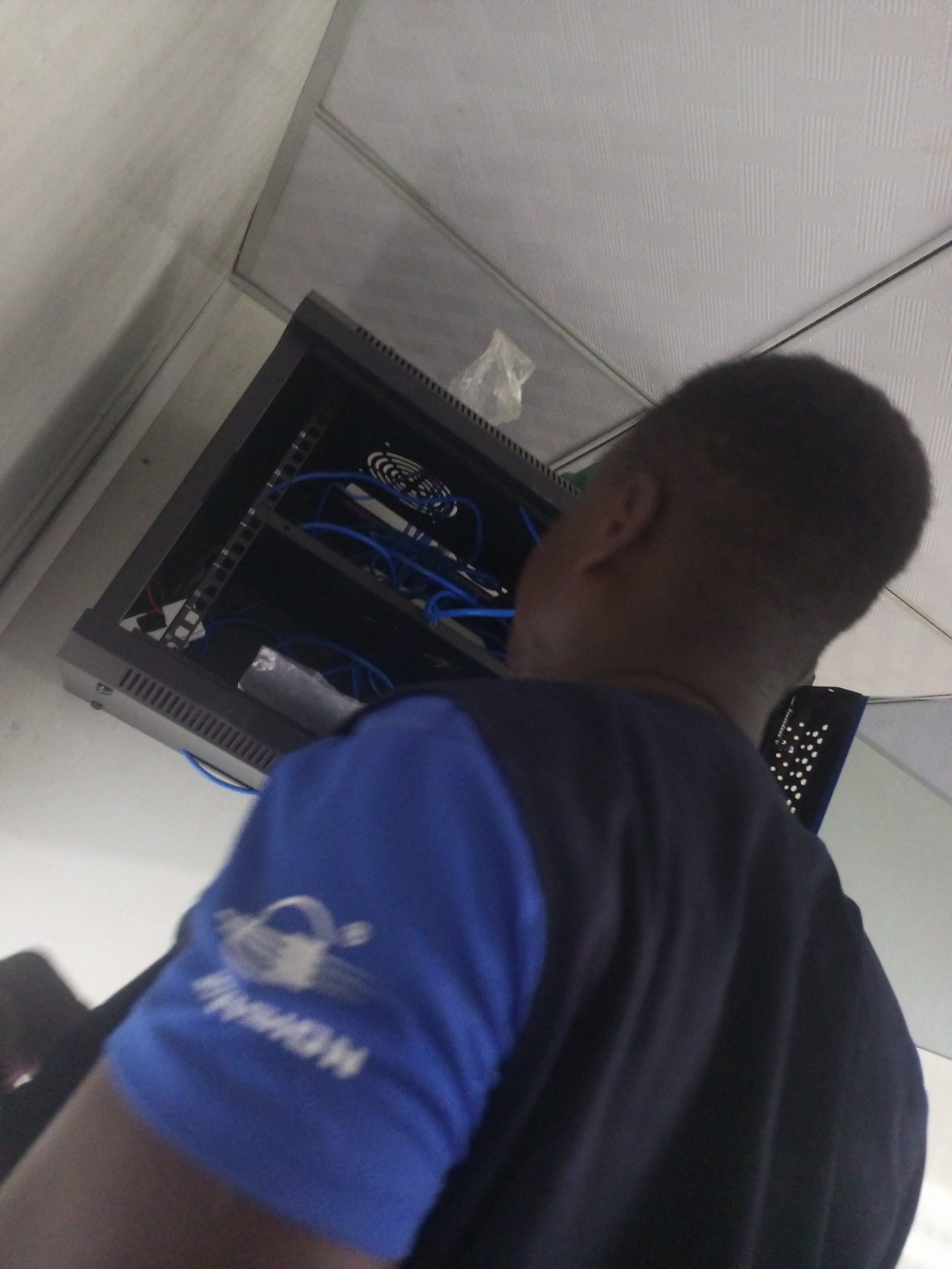 AerixSys technician installing and dressing cables on a network patch panel and rack