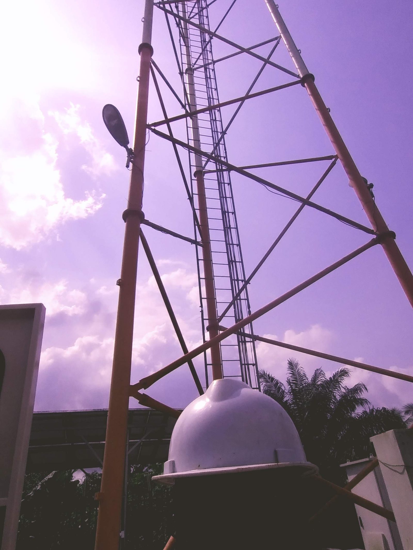 Telecom tower with radome installed by AerixSys, showing the mast, ladder and antenna structure